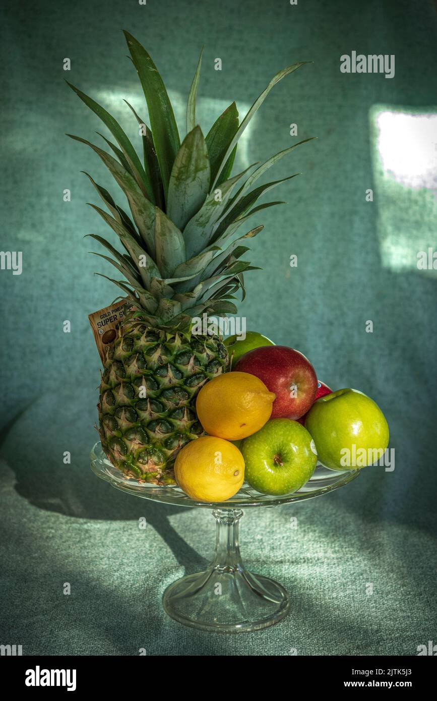 A glass vase ho;dong dofferent fruit, Stock Photo