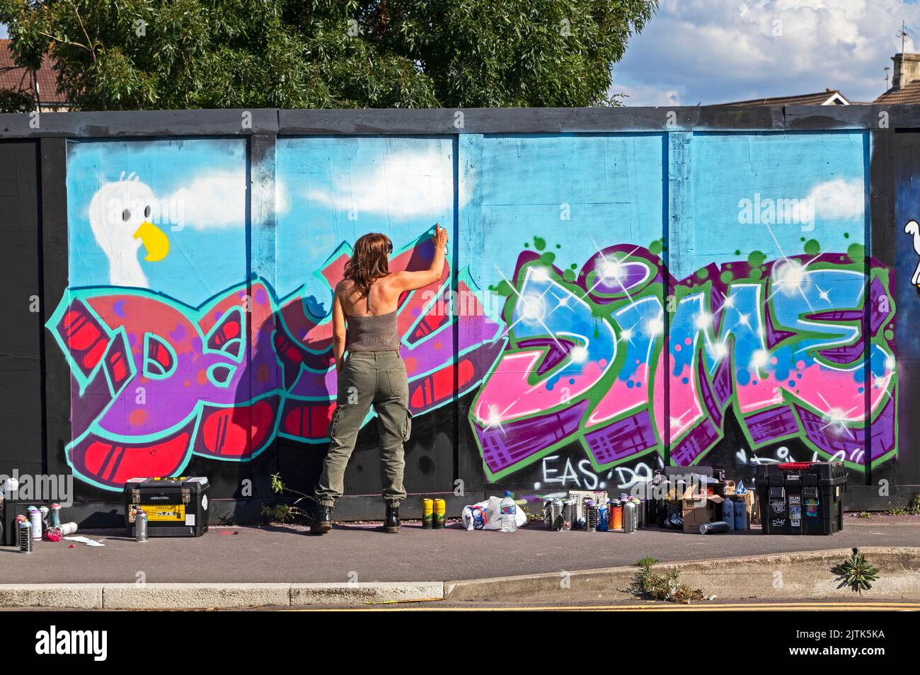 Weston-super-Mare, UK, 27 August 2022, An artist at work at a paint jam at the site of the town’s former police station. The police station was demolished in 2019 and the site is awaiting redevelopment. Stock Photo