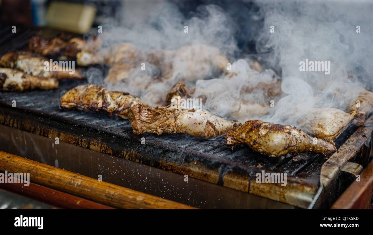 Tasty charcoal grilled caribbean jerk chicken at the Notting Hill Carnival. Stock Photo
