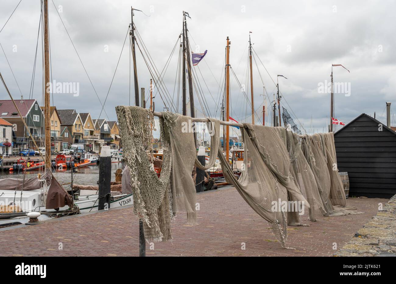 Urk, Province Flevoland, The Netherlands, 26.08.2022, Historic fishing town of Urk, view of fishing nets at the harbour Stock Photo