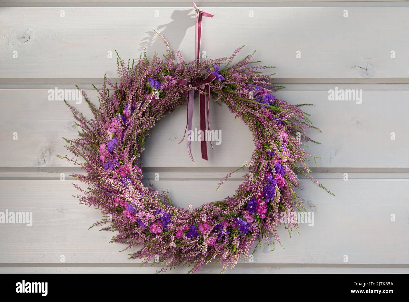 Autumn purple heather wreath decorating front door. Autumn fall concept Stock Photo