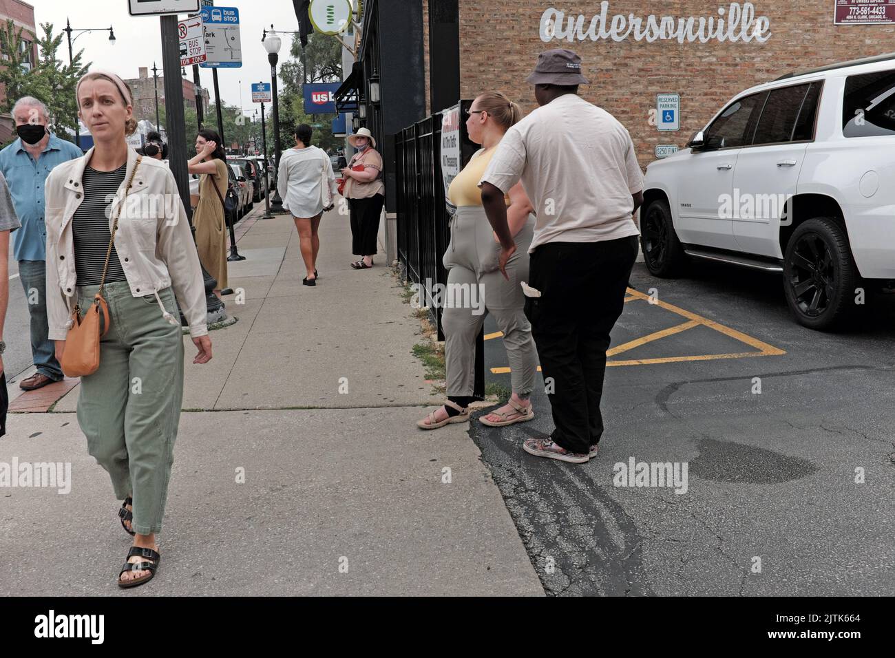 People on the sidewalks of Andersonville, Chicago, Illinois, create a lively streetscape. Stock Photo