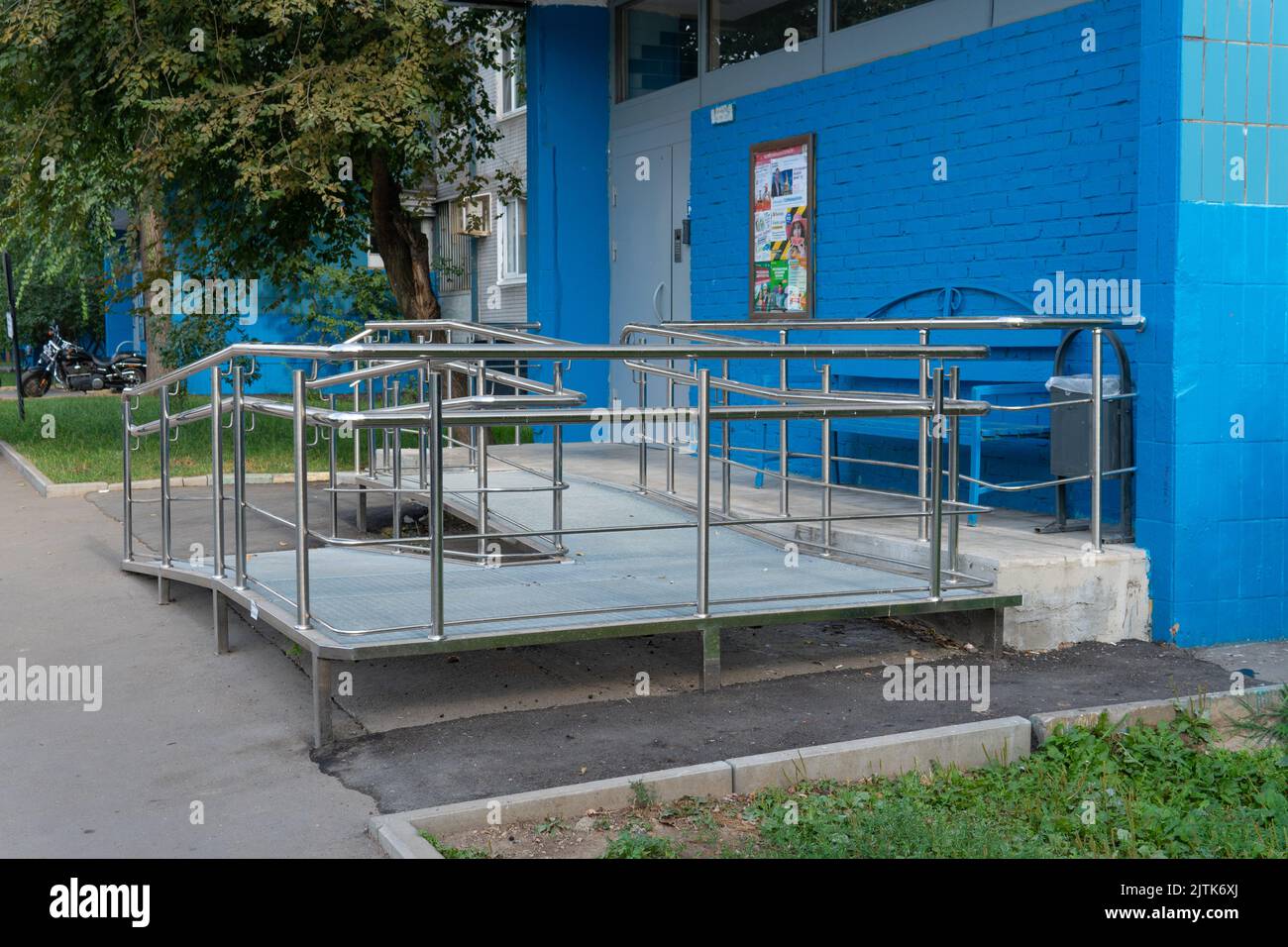 RUSSIA, MOSCOW - AUG 28, 2022: access disabled ramp wheelchair entrance chair building person help, from slope health for home from exit house, young Stock Photo