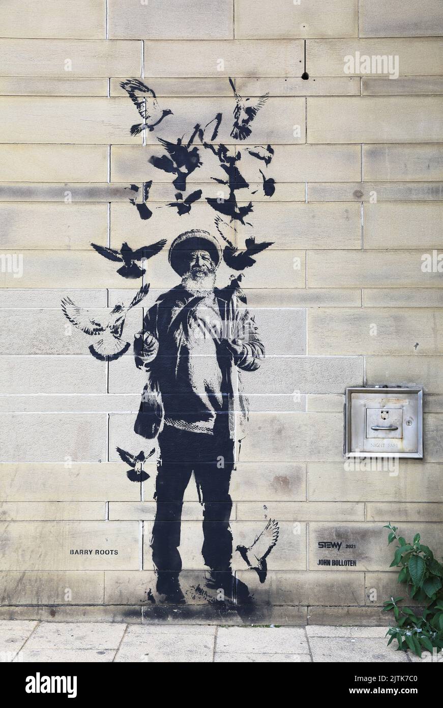 Barry Roots, the 'bird man', of Roots Record Shop, a DJ and reggae musician, on John Street, one of the of Bradford icons celebrated in street art. Stock Photo