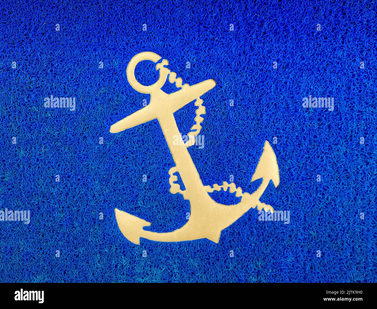 Gold boat anchor on bold blue textured background Stock Photo
