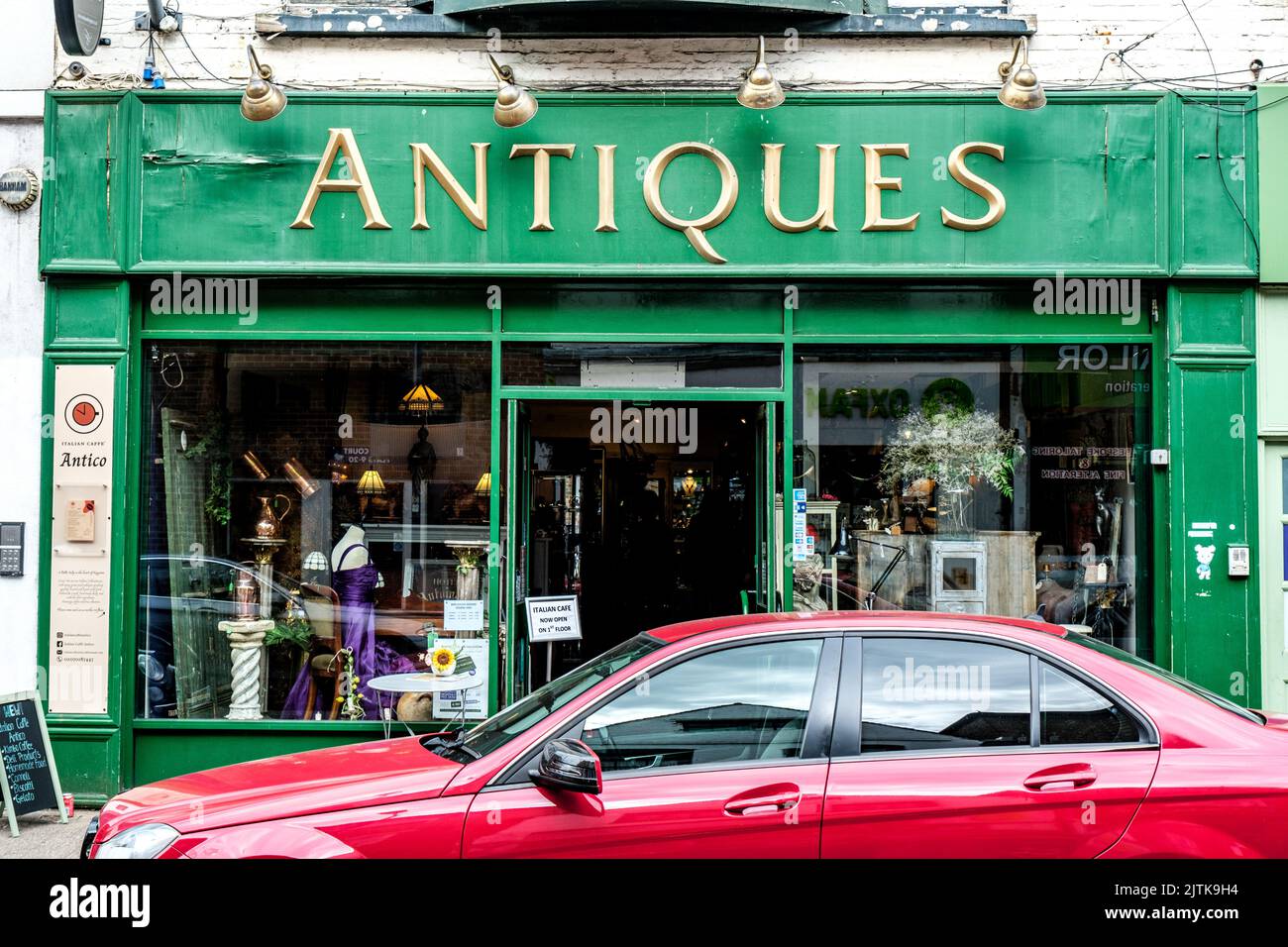 Kingston-Upon-Thames, London, UK, August 29 2022, Traditional Antique Shop With Red Car Parked Outside Stock Photo