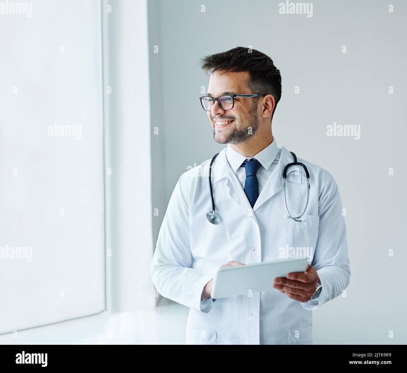 young doctor hospital medical medicine health care clinic office portrait glasses man stethoscope specialist tablet computer Stock Photo