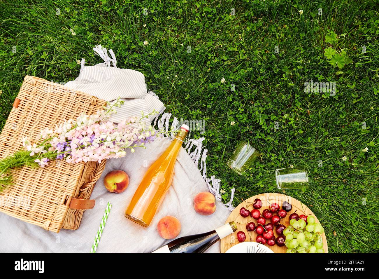 food, drinks and basket on picnic blanket on grass Stock Photo Alamy
