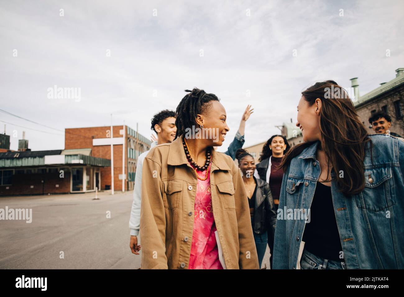 Smiling multiracial young friends enjoying on street in city Stock Photo