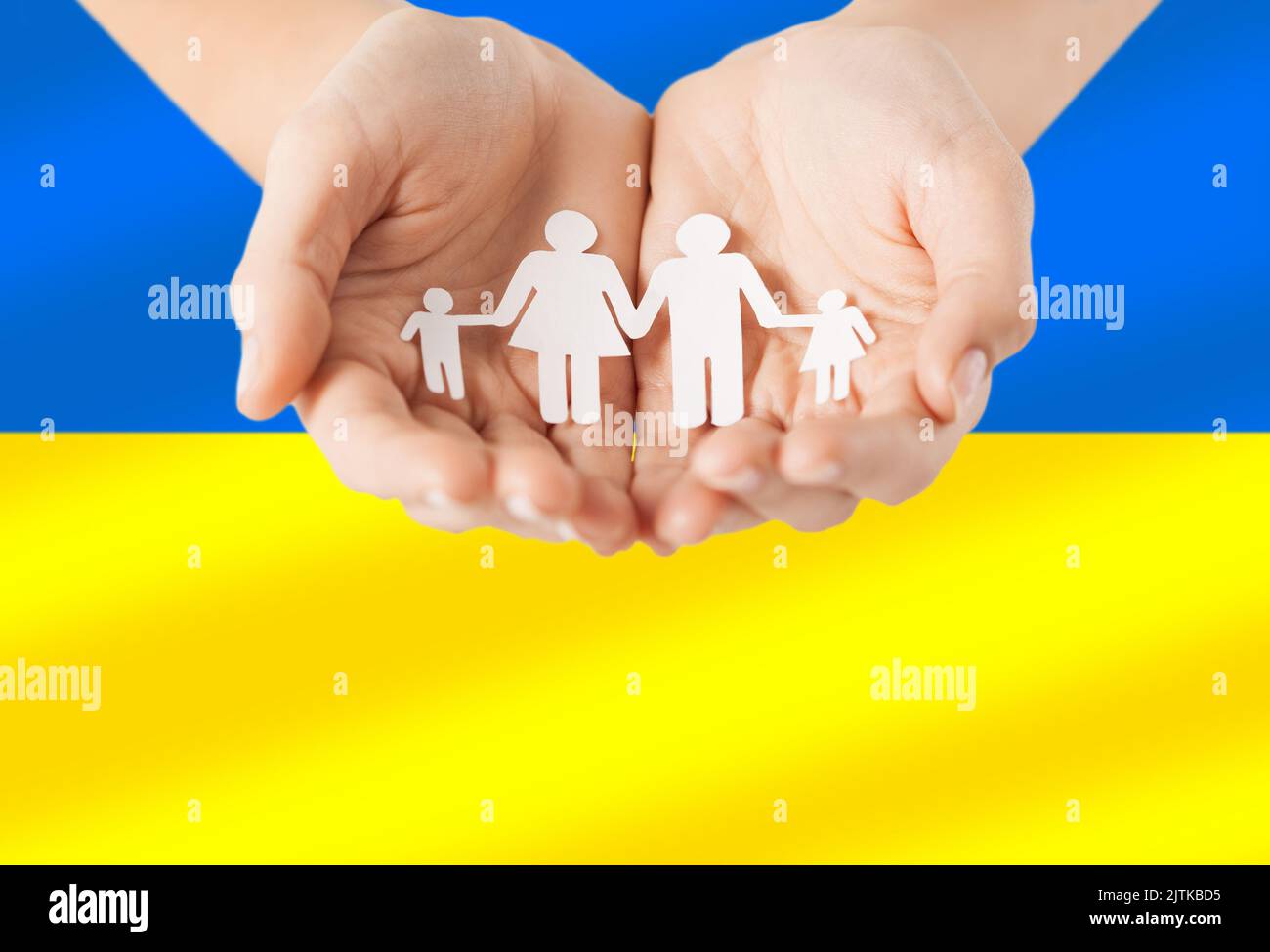 hands holding family icon over flag of ukraine Stock Photo