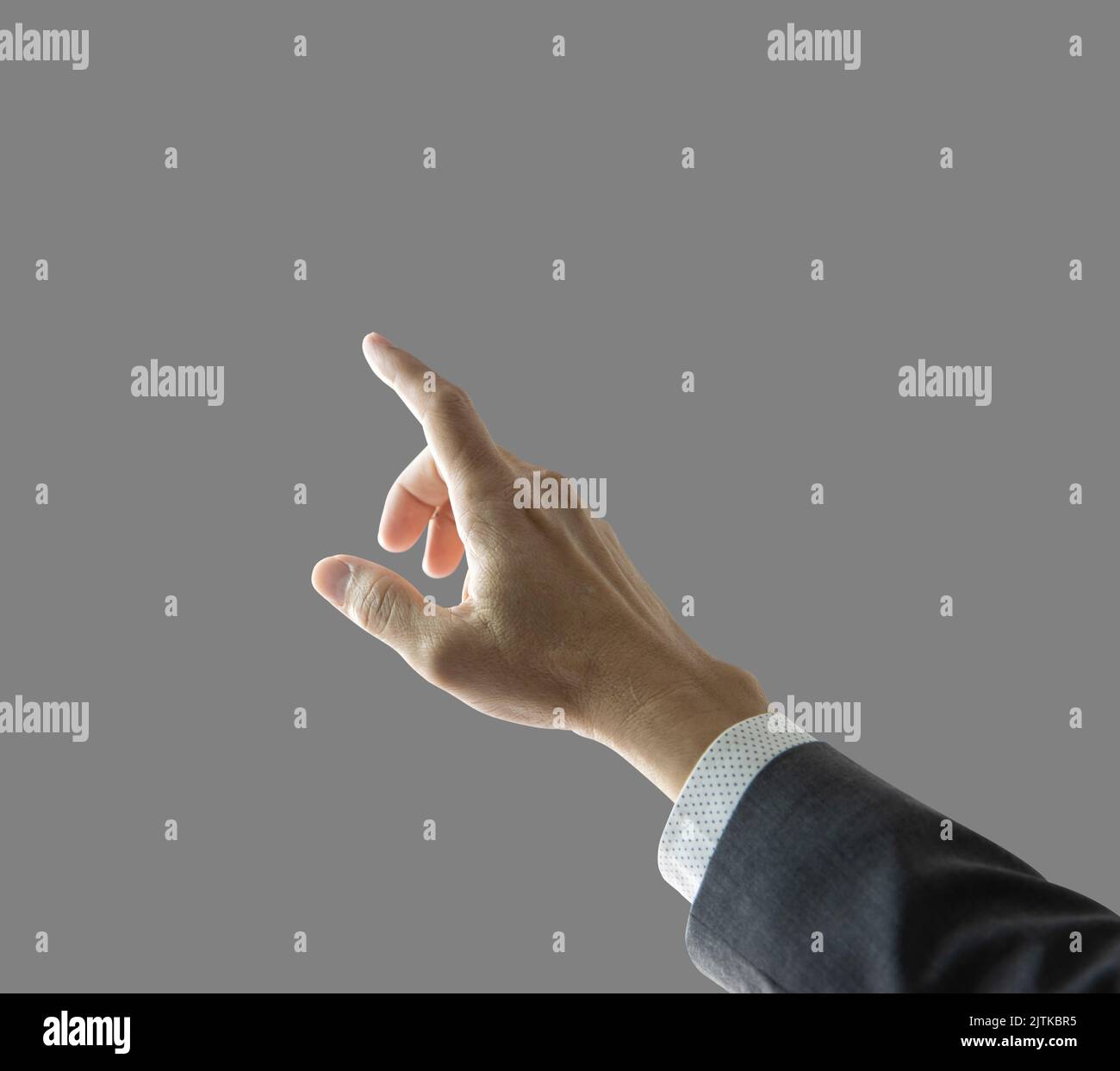 Right hand and forearm of a businessman with gray suit jacket sleeve with white shirt, pointing forward up showing touching something gesture. Isolate Stock Photo