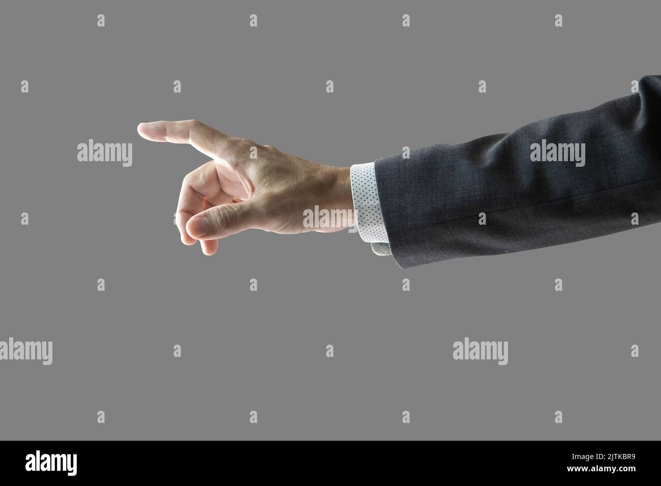 Right hand and forearm of a businessman with gray suit jacket sleeve with white shirt, pointing forward showing touching something gesture. Isolated o Stock Photo