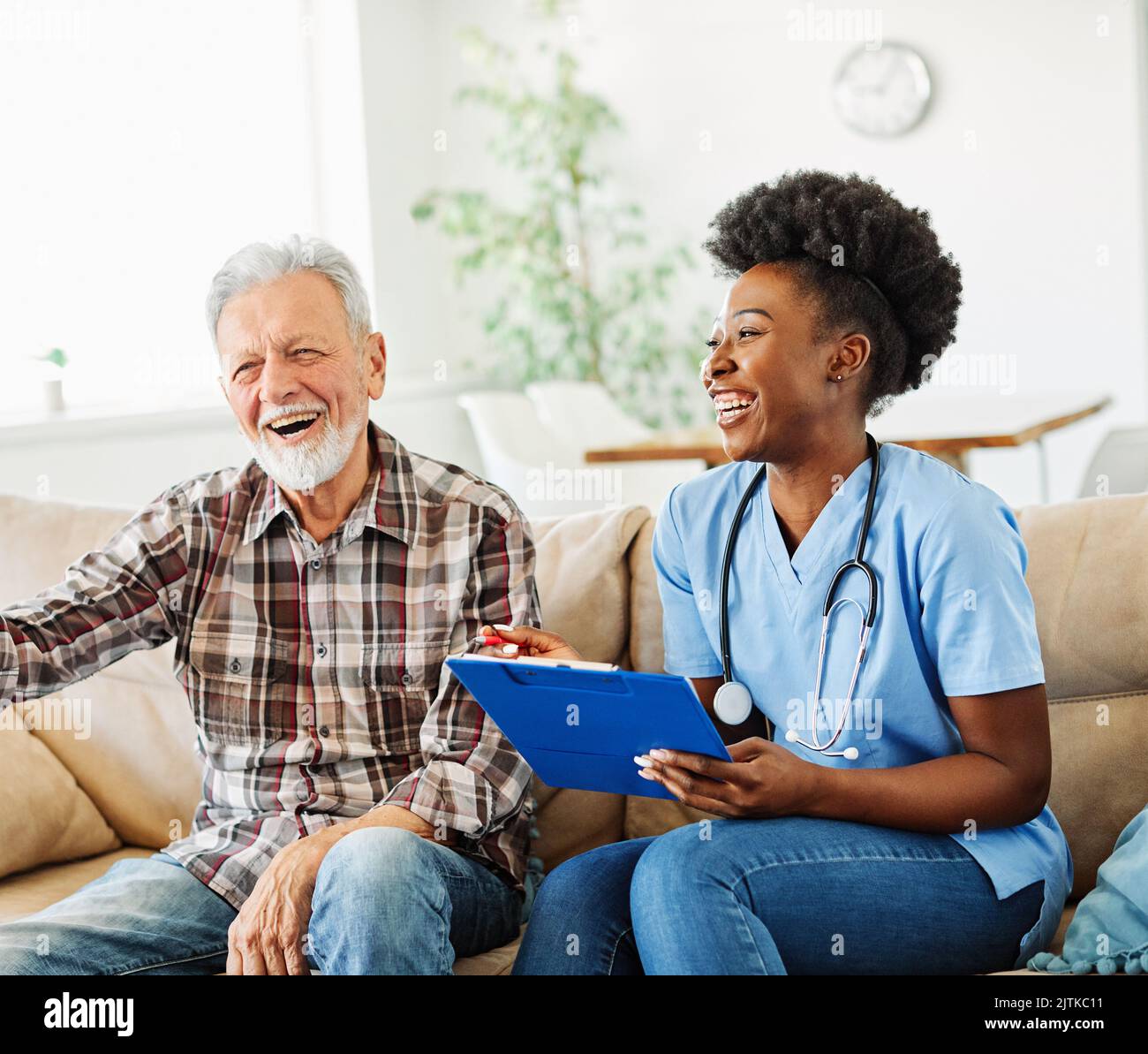 nurse doctor senior care caregiver help assistence retirement home nursing elderly man woman health support african american black Stock Photo