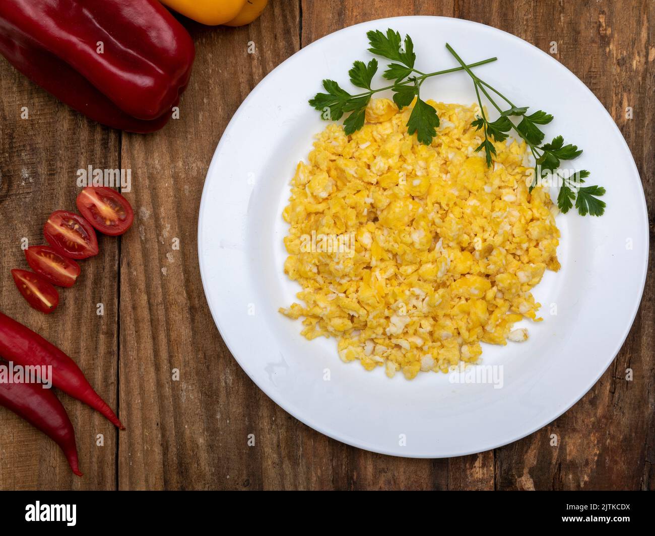 fresh scrambled eggs on white plate on breakfast table Stock Photo - Alamy