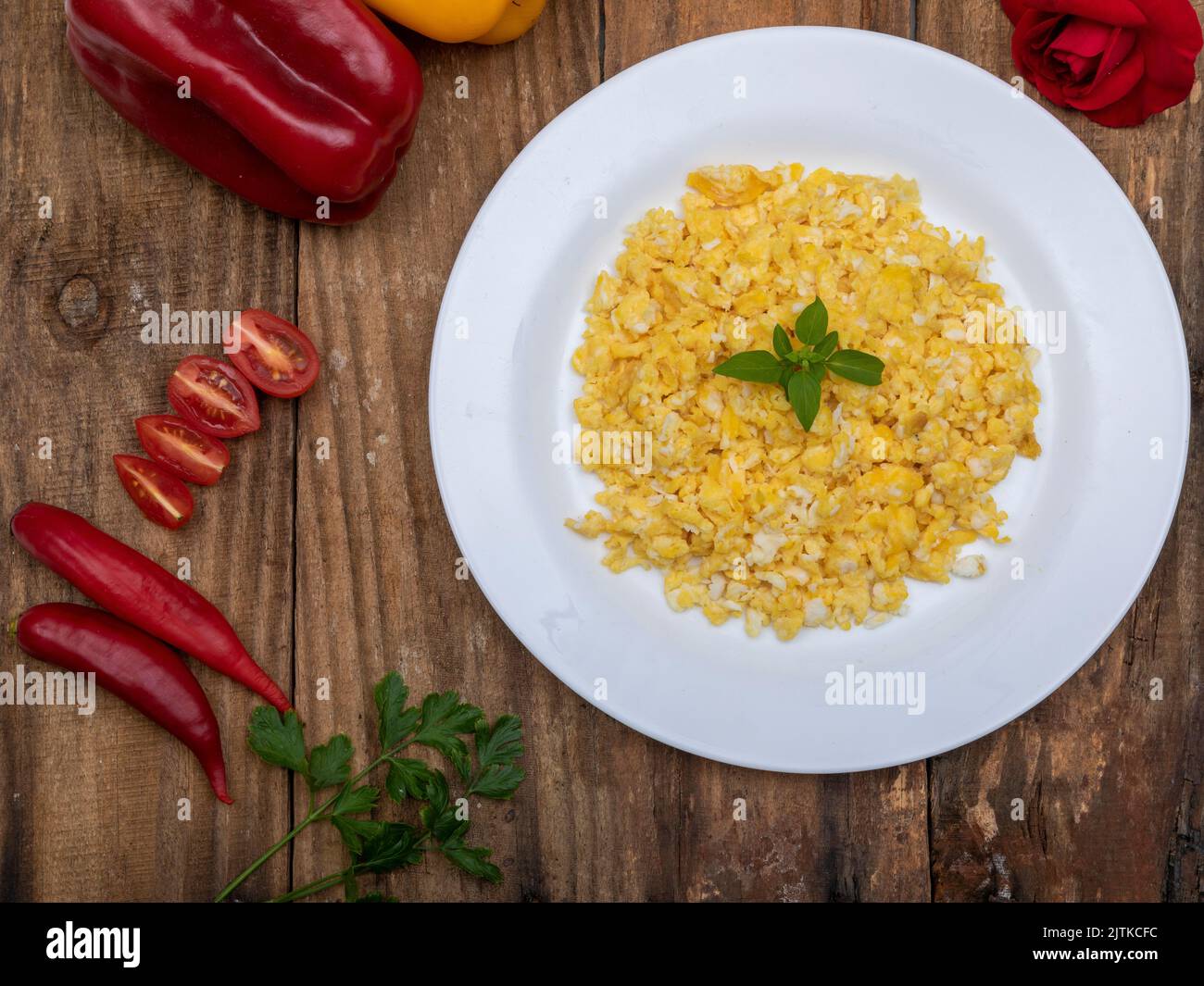 fresh scrambled eggs on white plate on breakfast table Stock Photo - Alamy