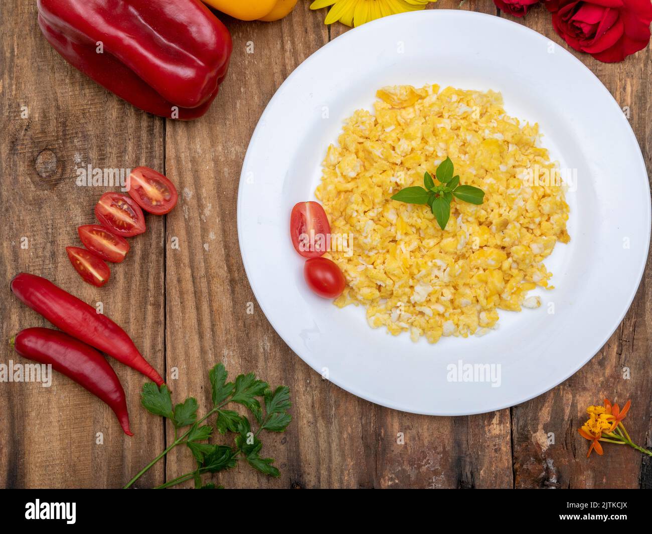 fresh scrambled eggs on white plate on breakfast table Stock Photo - Alamy
