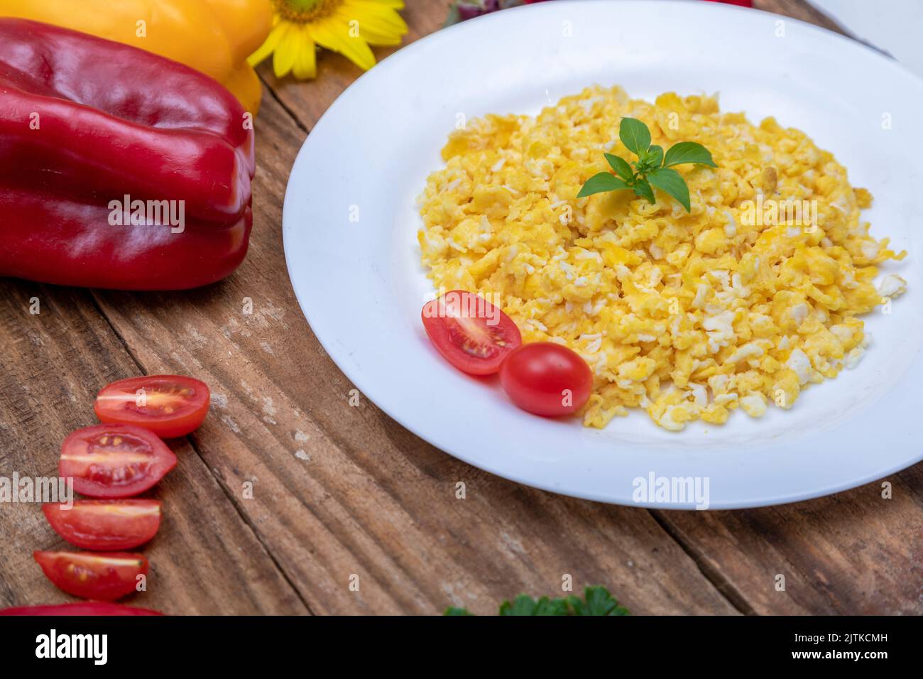 fresh scrambled eggs on white plate on breakfast table Stock Photo - Alamy