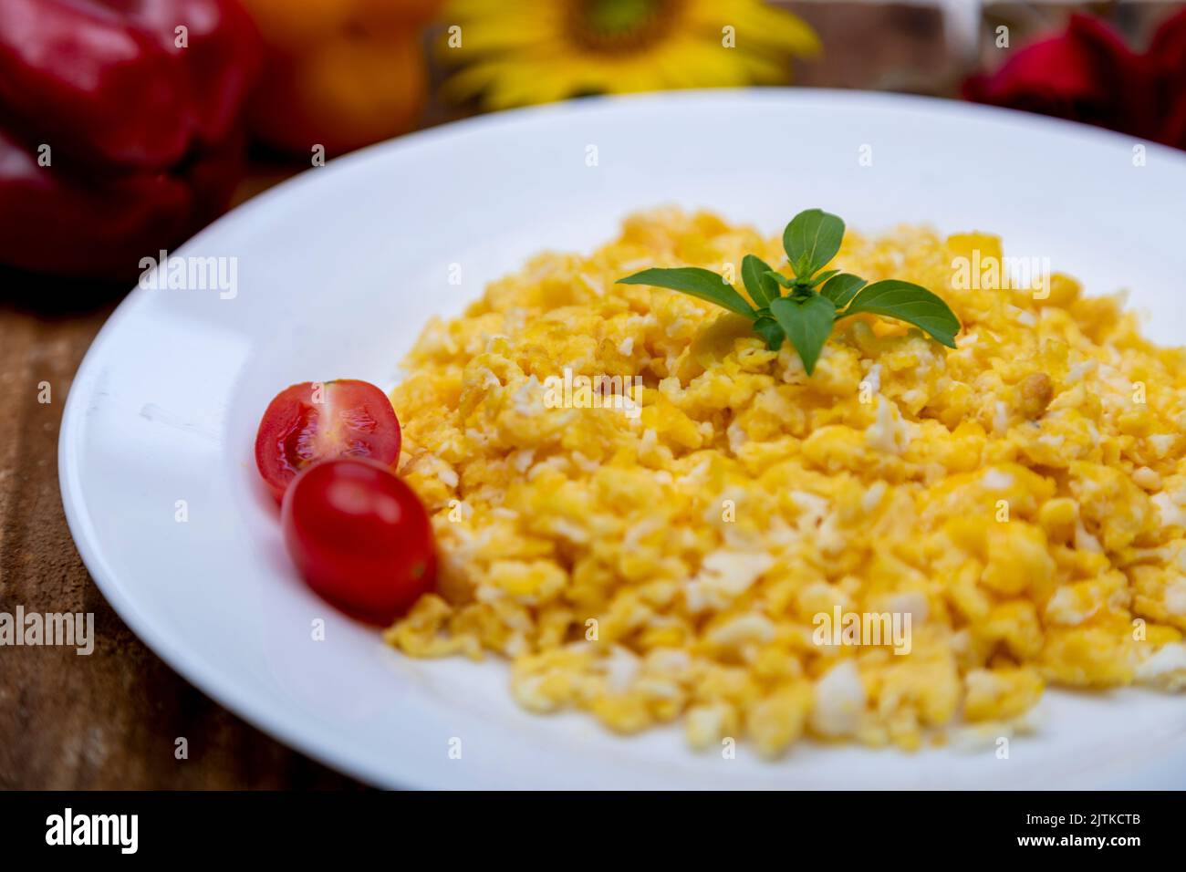 fresh scrambled eggs on white plate on breakfast table Stock Photo - Alamy