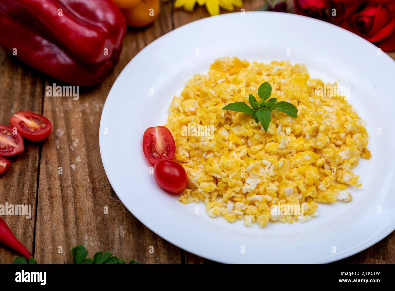 fresh scrambled eggs on white plate on breakfast table Stock Photo - Alamy
