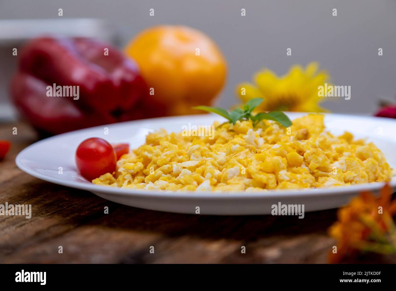 fresh scrambled eggs on white plate on breakfast table Stock Photo - Alamy