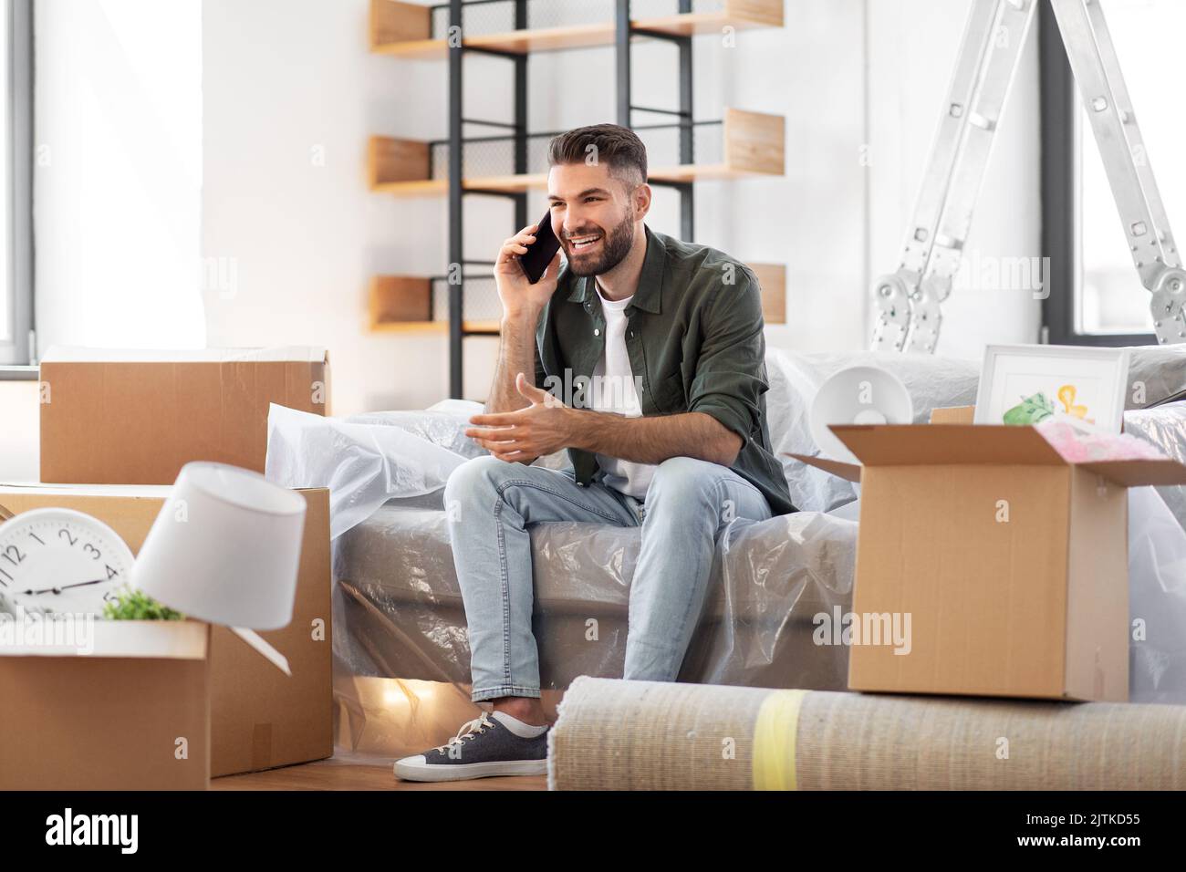 happy man calling on smartphone moving to new home Stock Photo Alamy