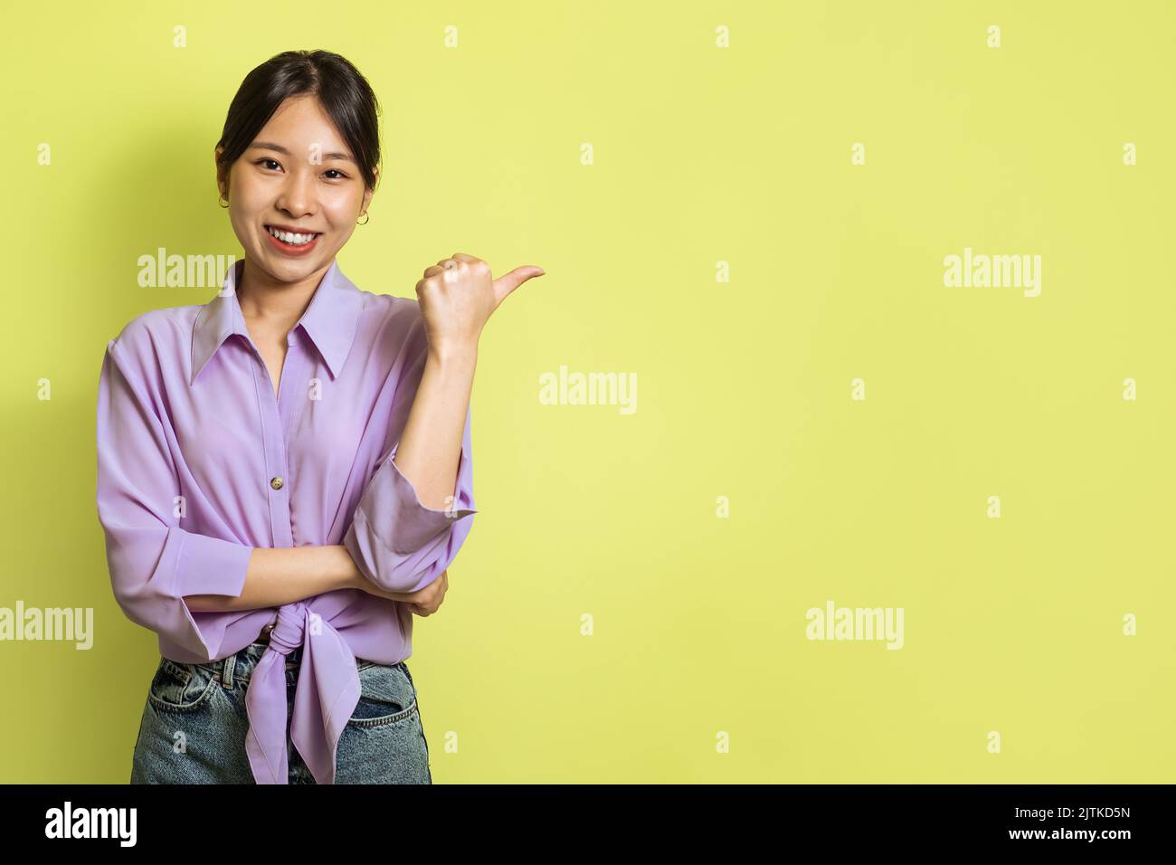 Woman pointing finger thumb hi-res stock photography and images - Alamy