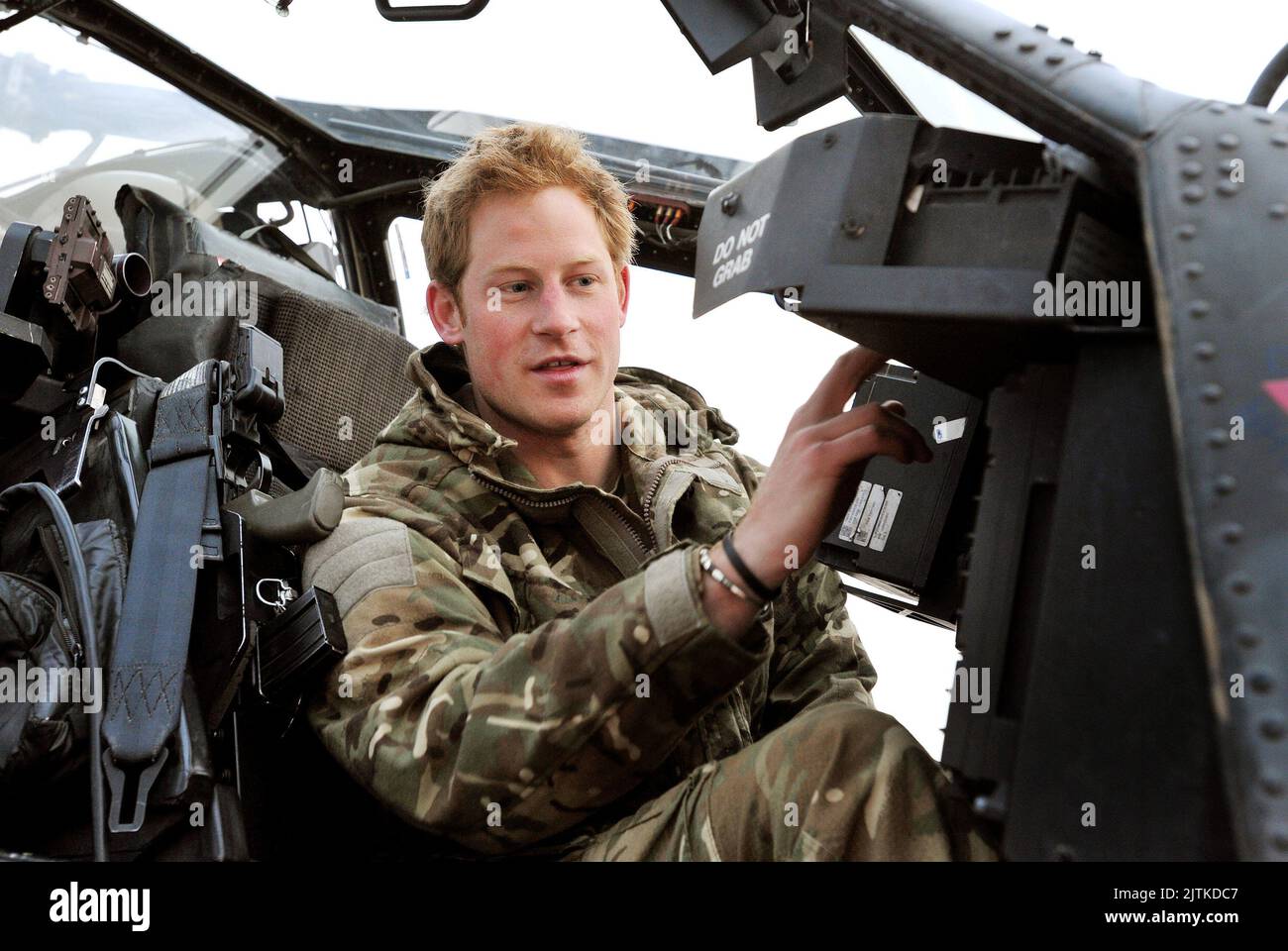 File photo dated 12/12/2012 of Prince Harry or Captain Wales as he was known in the British Army, making his early morning pre-flight checks in the cockpit, at Camp Bastion, southern Afghanistan. The Duke of Sussex has consoled Lee Spencer, a former royal marine who had to pull out of an epic Triathlon of Great Britain challenge, telling him he should be 'really proud' of his achievements. Harry video-called Lee, a single leg amputee, who was left devastated when forced, due to injury, to end his bid to swim the English Channel, cycle from Lands End to John O'Groats and climb the three highest Stock Photo