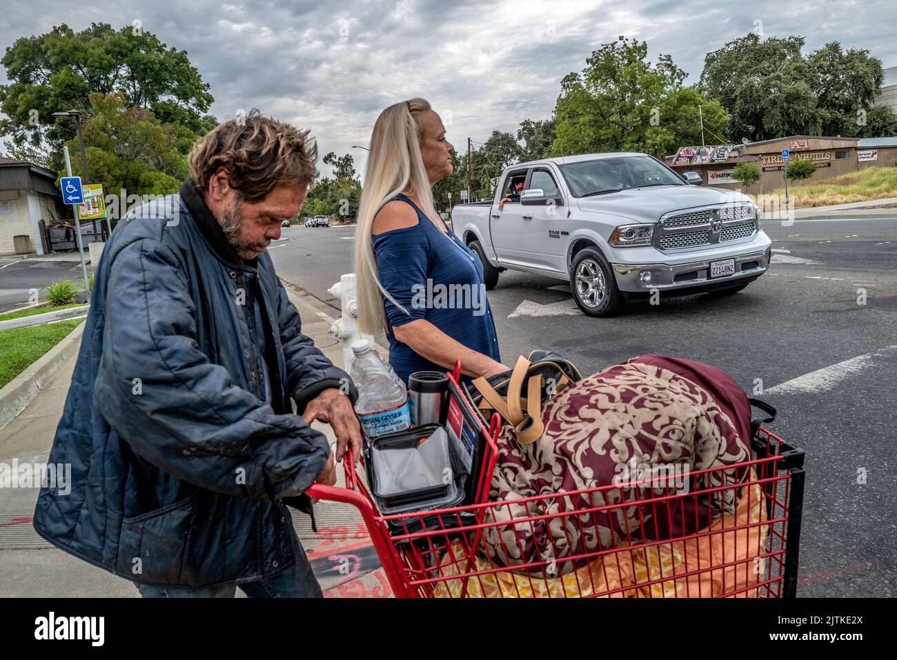Vacaville, California, USA. 1st Aug, 2022. LINDA PRIVATTE, 65, guides her brother MARK RIPPEE, 59, who is blind and mentally ill, across an intersection in Vacaville. 'He has delusions that won't allow him to leave this particular area. It's all that he remembers before he went blind, ' said Privatte. (Credit Image: © Renee C. Byer/Sacramento Bee/ZUMA Press Wire) Stock Photo