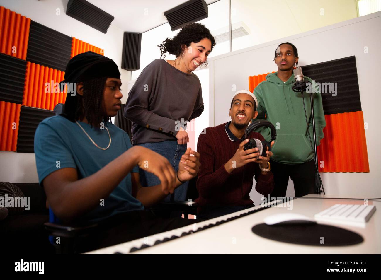 Portrait of rappers and sound engineers in recording studio Stock Photo