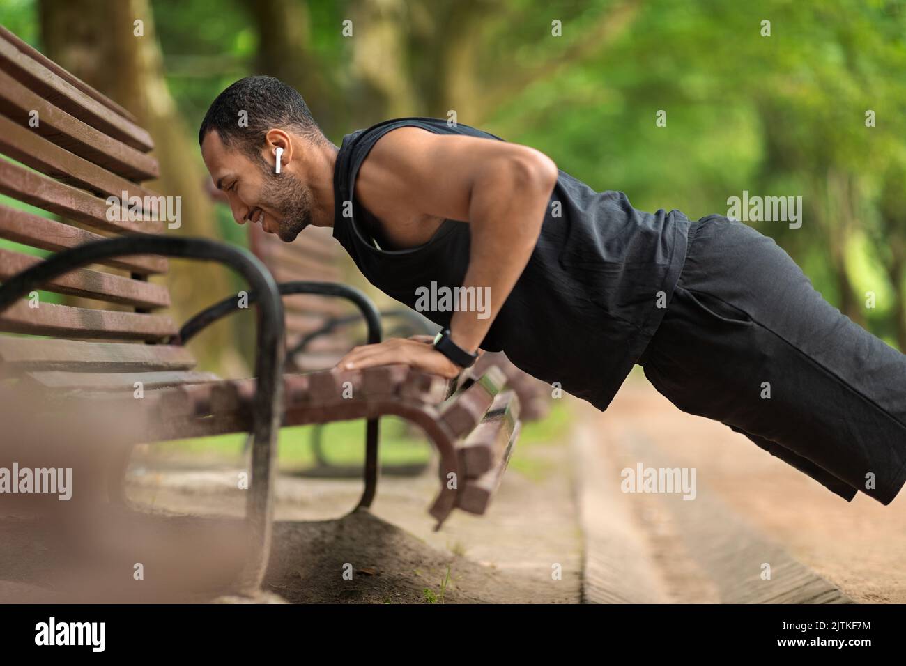 Happy black guy sportsman doing push ups at public park Stock Photo - Alamy