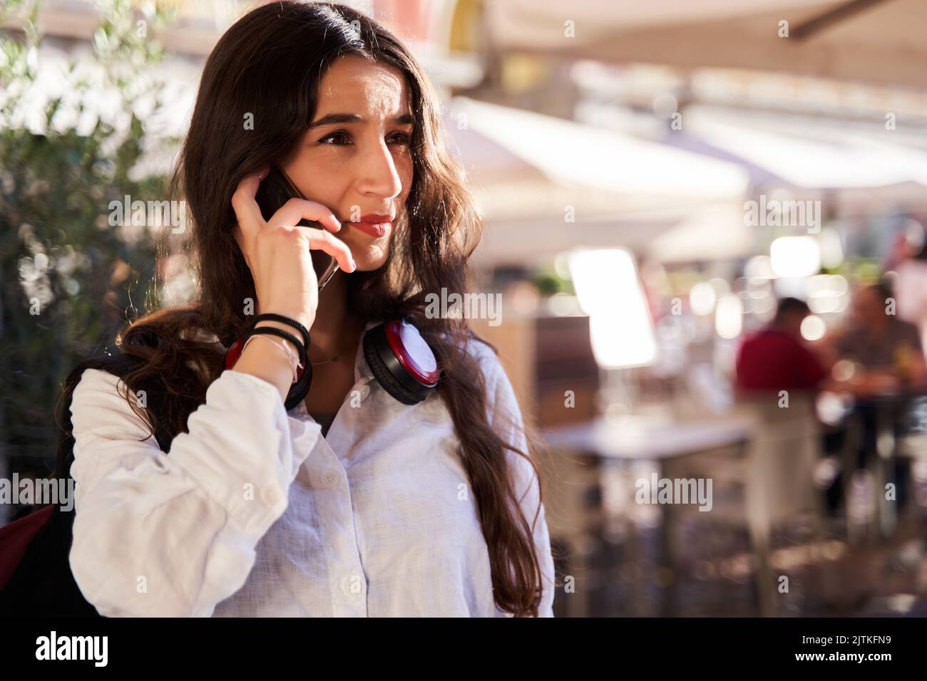 young woman talking on her smart phone with text copy space Stock Photo