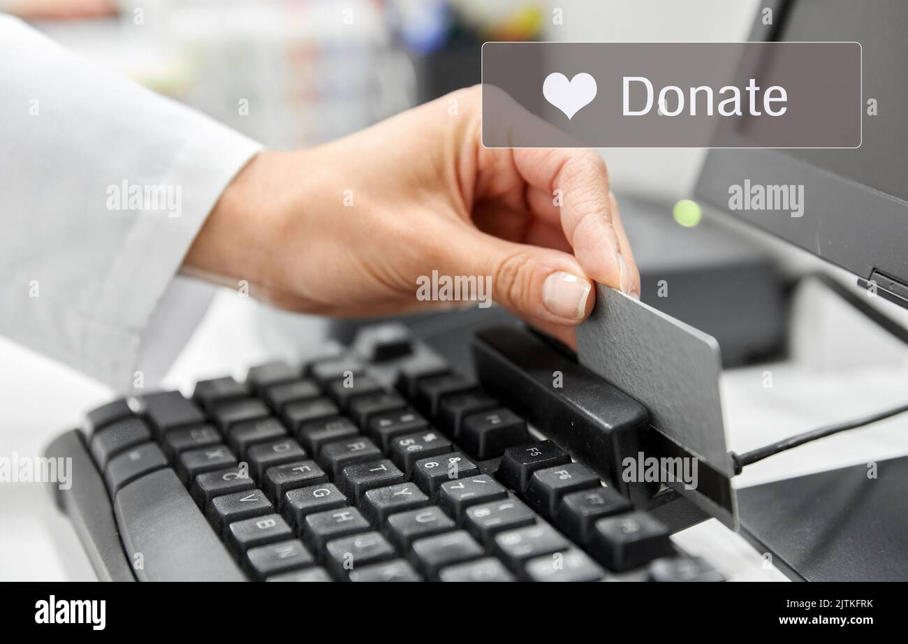 hand with credit card making donation online Stock Photo Alamy