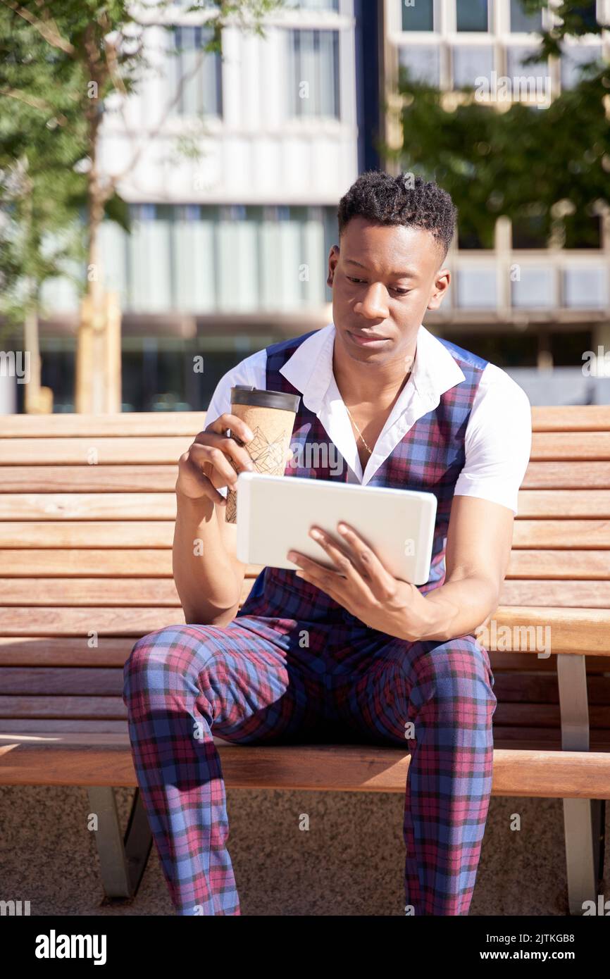 african american young man with tablet computer and take away coffee Stock Photo