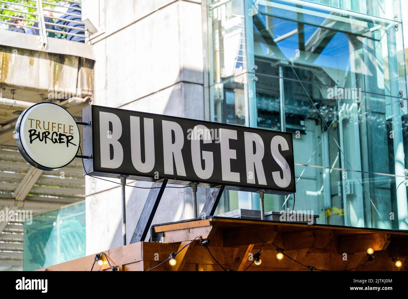 LONDON - May 20, 2022: Burgers sign above fast food take away hut on South Bank Stock Photo