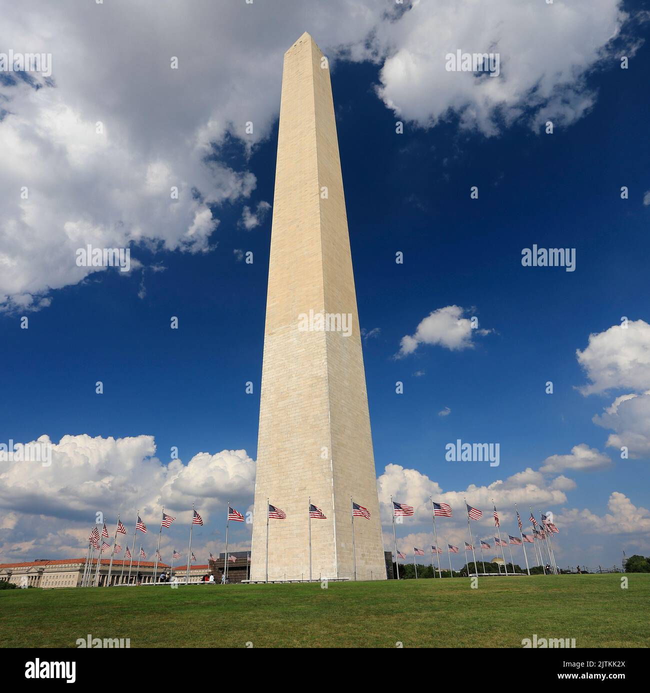 Washington Monument with American flags waving and US Capitol in District of Columbia Stock Photo