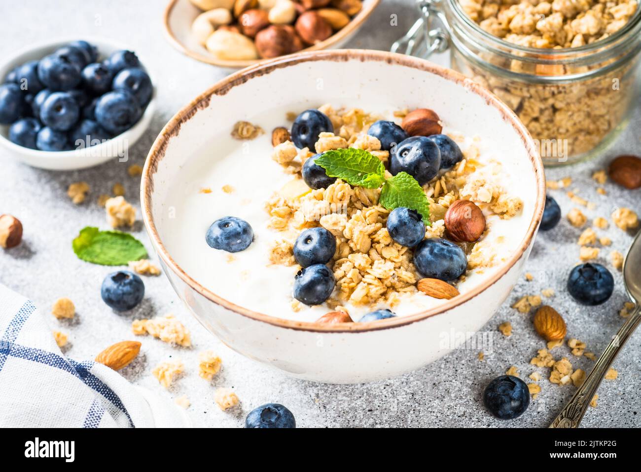 Yogurt granola with fresh blueberries on stone table. Stock Photo