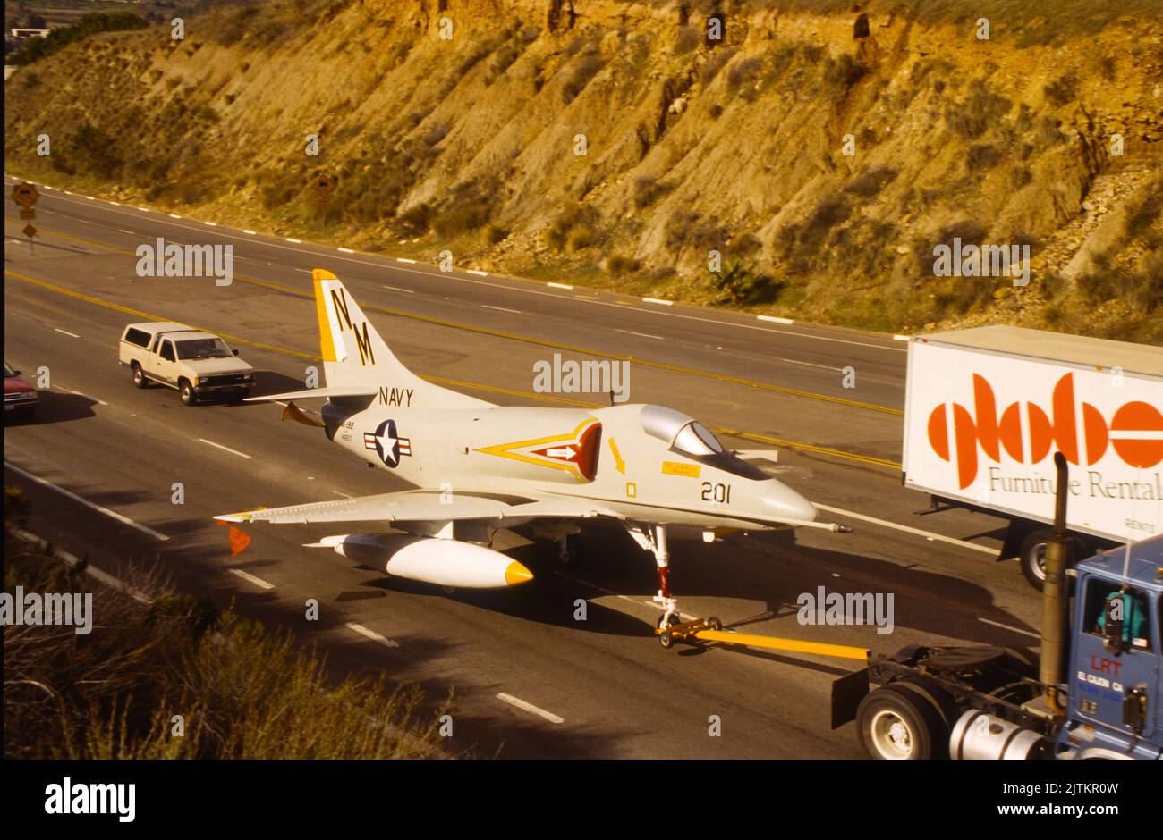 Douglas A-4 Skyhawk is towed on the street on the way to the San Diego Aerospace Museum hanger annex at Gillespie Field in El Cajon, California Stock Photo