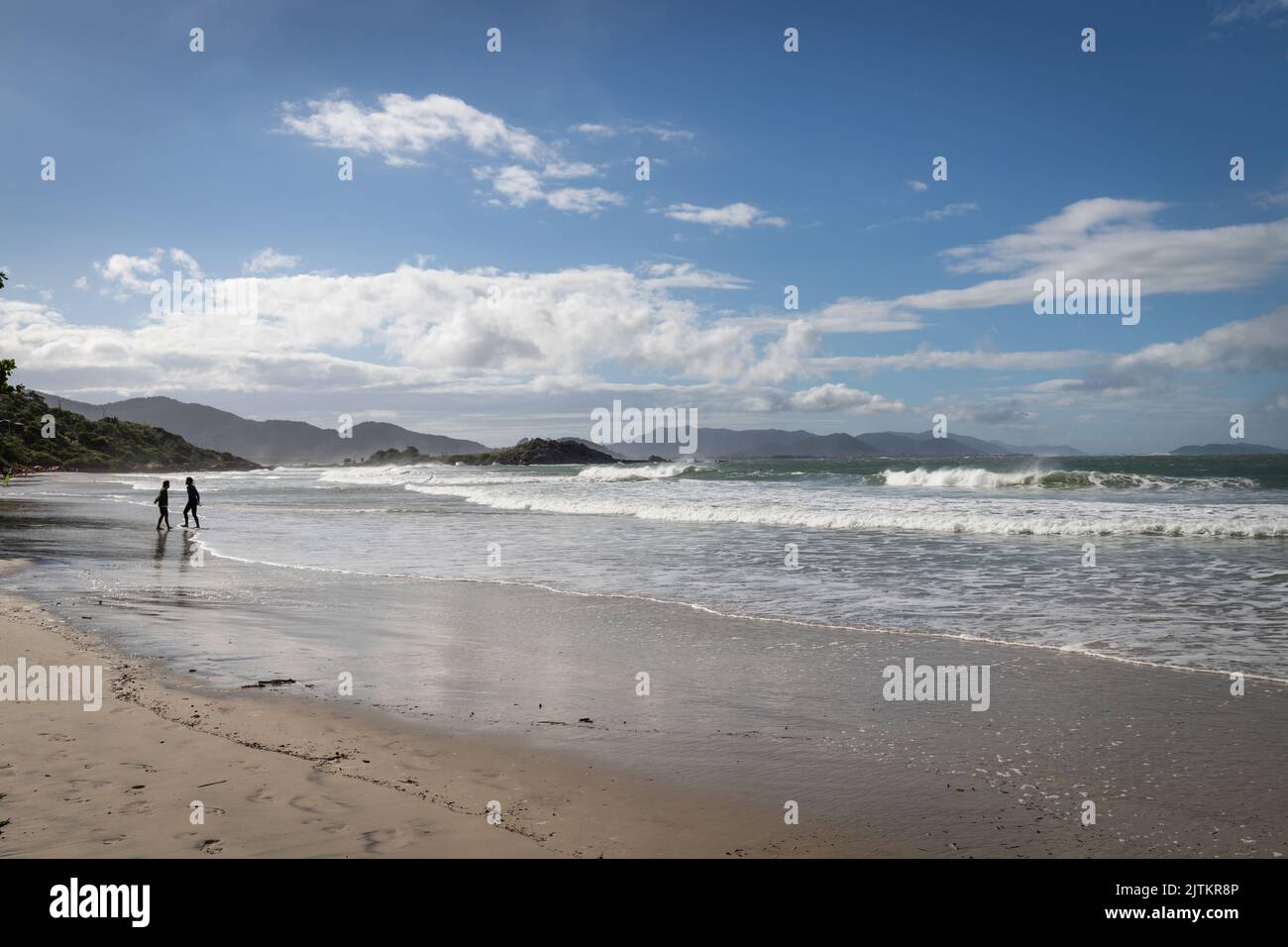 A sunny day on the beach with a cloudy sky above Stock Photo - Alamy