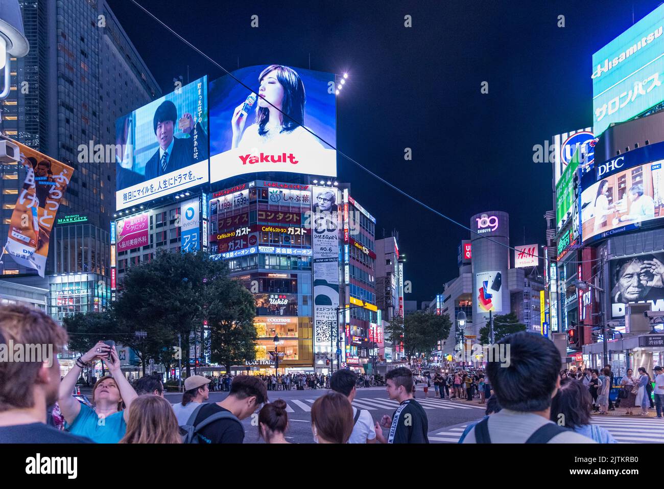 Tokyo, Shibuya, Japan - July 27, 2019: Shibuya intersection in Tokyo at night one of the busiest pedestrian crossings. Stock Photo