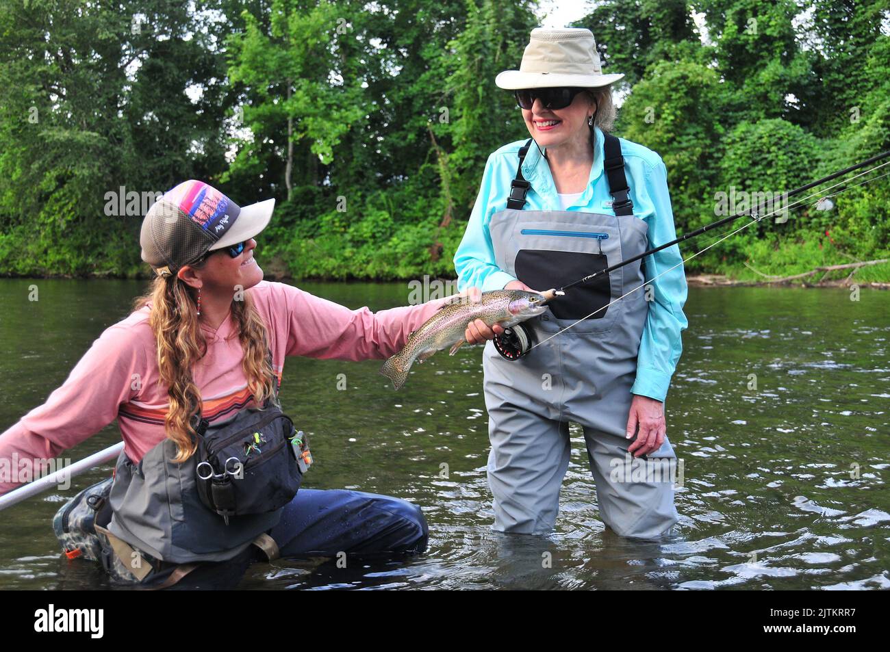 A guide nets a beautiful trout for an angler in North Carolina's