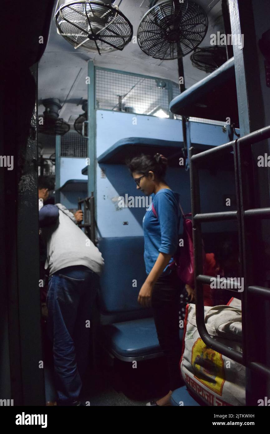 Indian rail travelers with luggage. Stock Photo