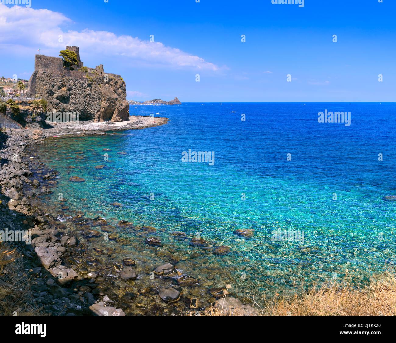 Norman old medieval Castle Aci Castello with stone walls on rock coast of Ionian Sea near Catania in Sicily, Southern Italy. Stock Photo