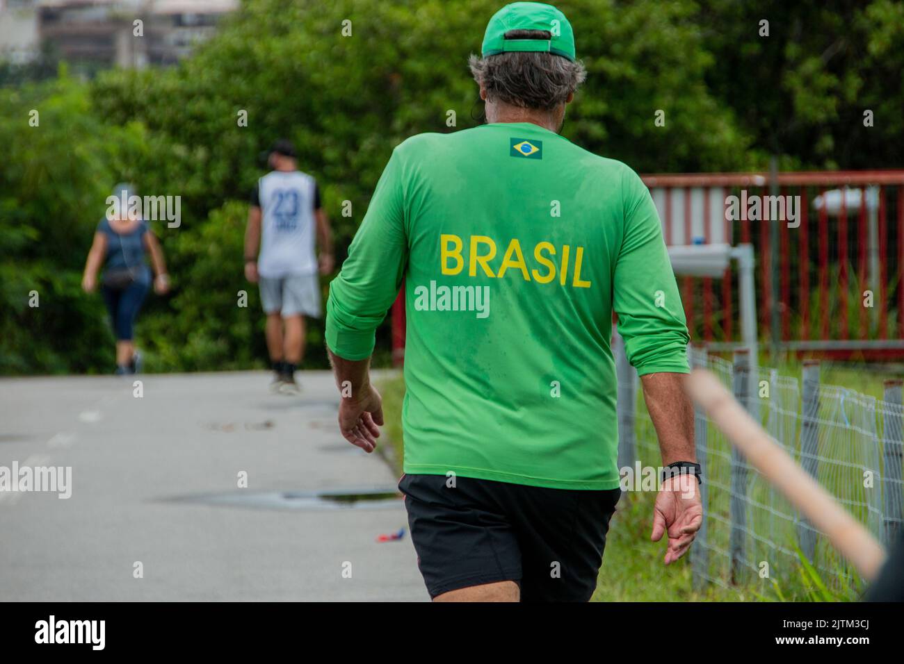 person walking with a green shirt written brazil with yellow letters in ...