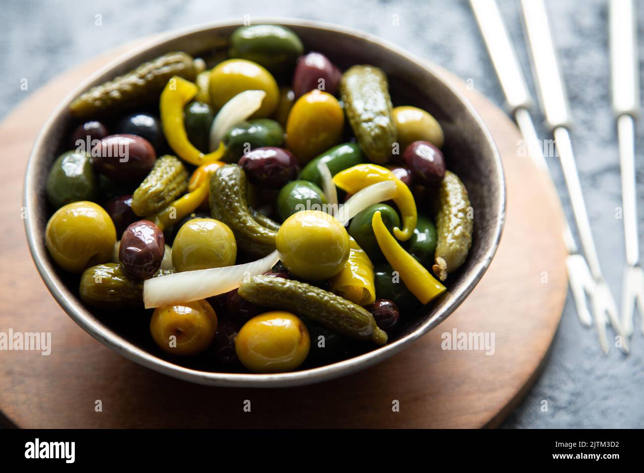 Pickled gherkins, onion, chilli and various types of olives in a bowl Stock Photo Alamy
