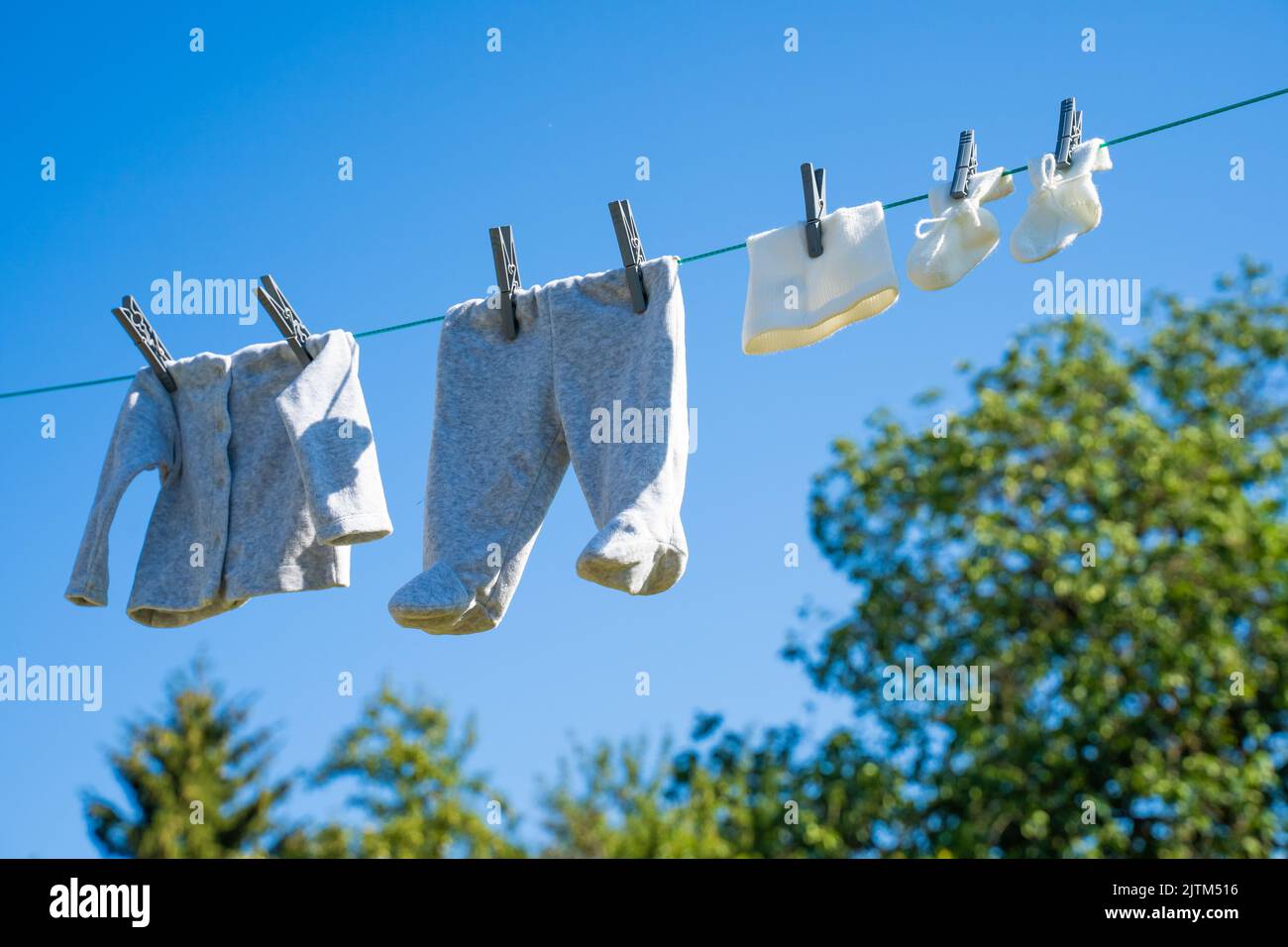 baby clothes dry in the sun Stock Photo - Alamy