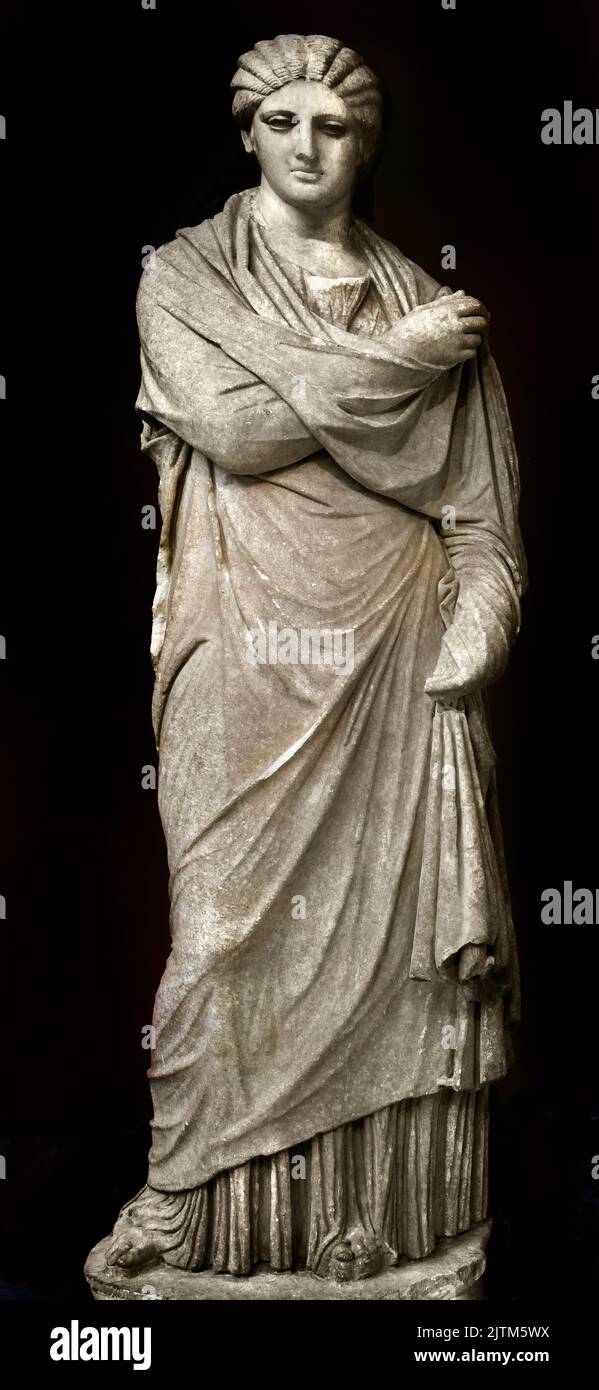 Female statue Pentelic marble Found at Aigion Peloponnese,Small Herculaneum Style, 300 BC,  Athens ,Archaeological Museum,National Archaeological Museum in Athens. ( wearing a full length chiton and a himation thar covers her entire body, ) Stock Photo