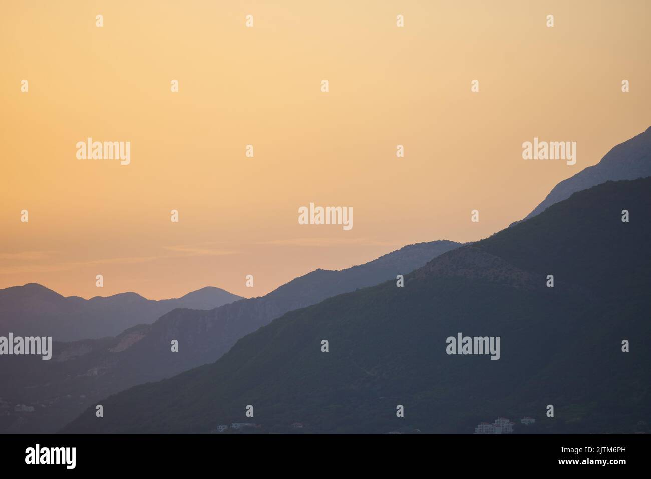 Evening mountain range view at golden hour Stock Photo