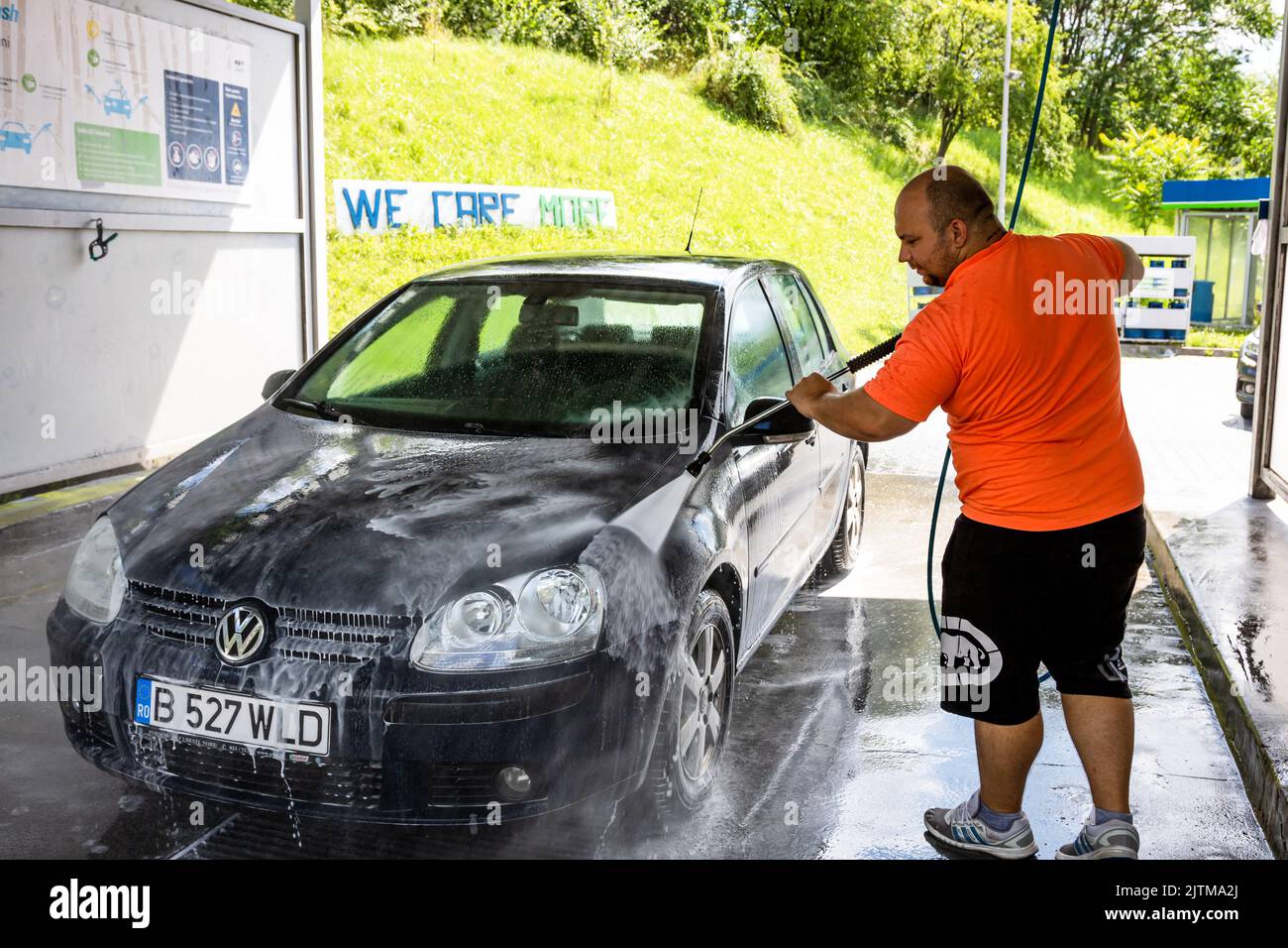 Washing and cleaning car in self service car wash station. Car washing
