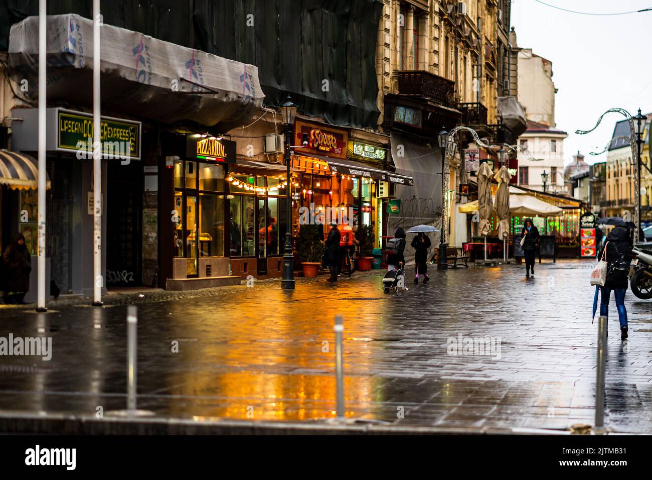 People and tourists wander the streets of the Bucharest Old Town