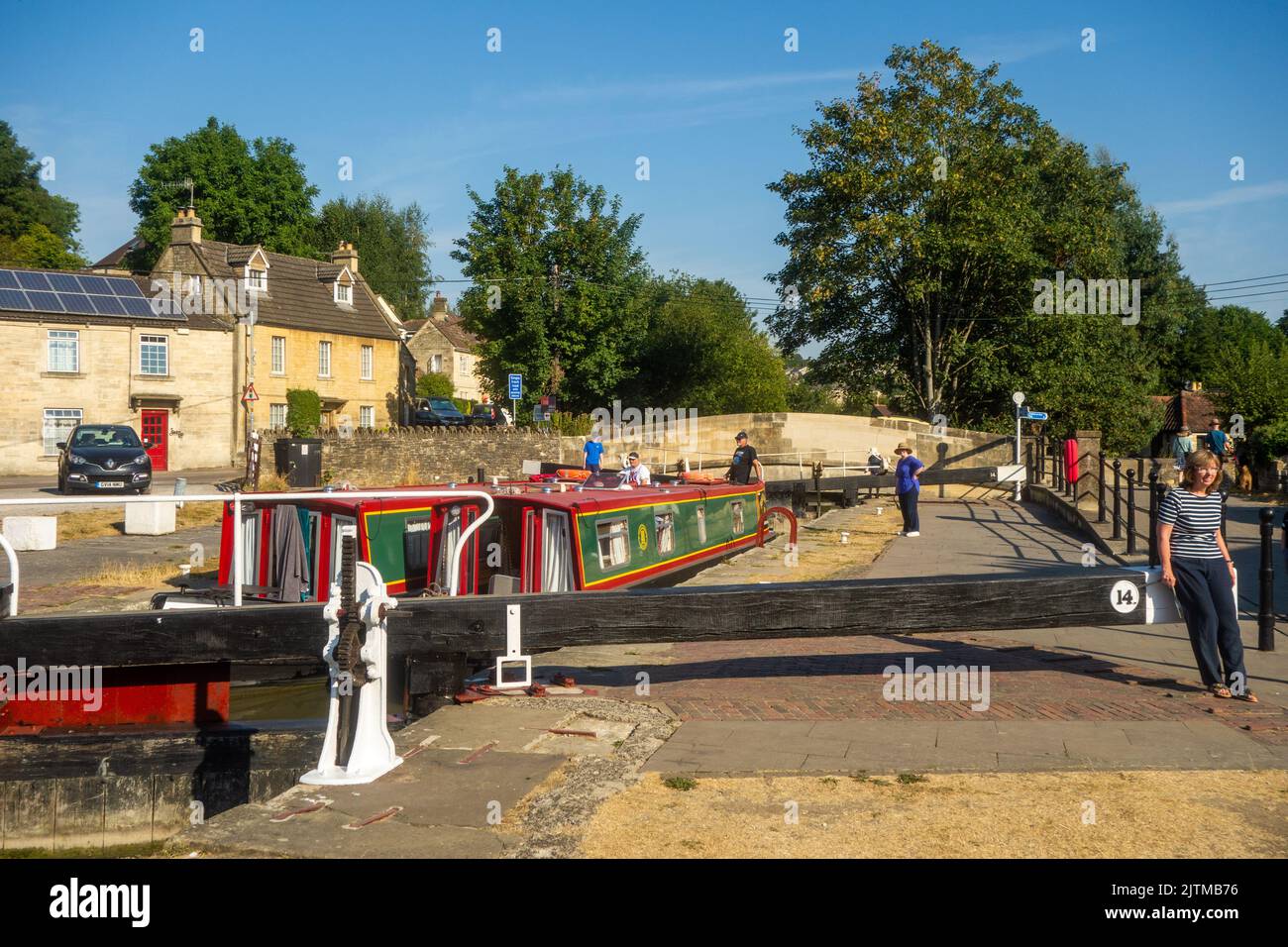 Canal narrowboat passing through Bradford locks on the Kennet and Avon canal at Bradford on Avon Wiltshire Stock Photo